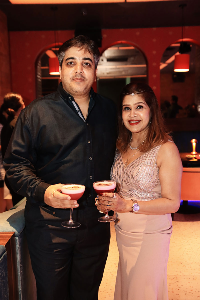 Puneet Malhotra and Neeta Malhotra cheering with cocktails in their hands at Queen’s Tandoor Indian Restaurant Seminyak Bali